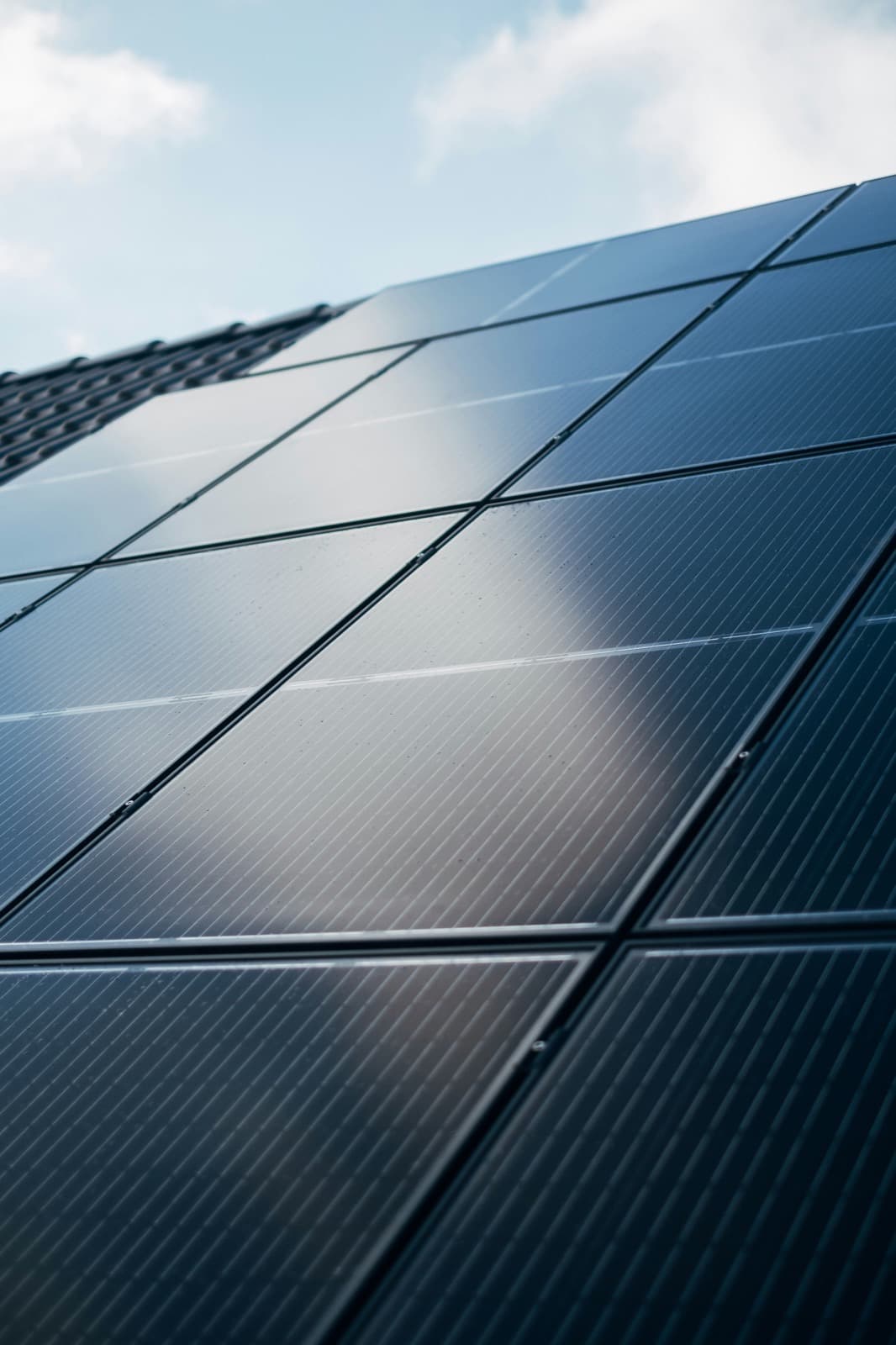 Close-up of solar panels reflecting the sky